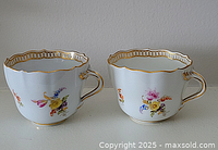 Front view of both teacups side by side showing overall shape and painted decoration