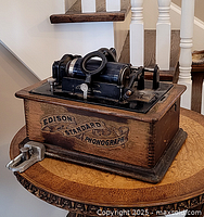 Side view of the Edison Standard Phonograph showing wooden case and playback mechanics.