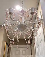 Photo from below showing six lights with glass bobeches and pink and clear crystal droplets hanging