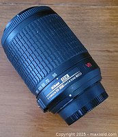 Side view of Nikon Nikkor 55-200mm lens showing model and specifications.