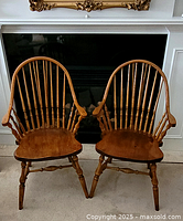Pair of Windsor armchairs side by side in front of fireplace