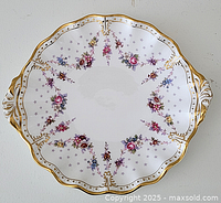 Top-down view of entire cake dish showing floral pattern and gold trim