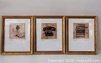 Three framed vintage prints showing an oil lamp with book and glasses, a rotary telephone, and a vintage typewriter.