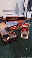 Photo of Black & Decker BV290 blower in box alongside boxed solar lights, some unboxed and displayed.