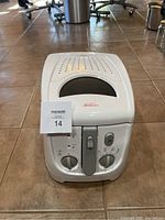 Front view of white Sunbeam deep fryer with controls visible, showing brand logo, control dials for temperature and timer, and basket handle.