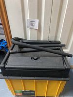 Four black tubular parts likely for assembly or handle attachment