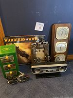 All items together showing the set including the John Deere tin, calendars, motorcycle picture frame, and temperature gauges.