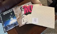 Four LP covers laid out side by side showing Parasite, Led Zeppelin, Rush and Pink Floyd “The Wall.”