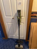 Full assembled vacuum upright against door
