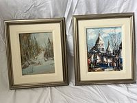 Two framed paintings showing landscape and cityscape, both signed McGrach.