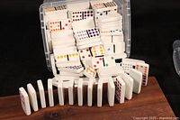 Domino tiles spread with some standing and some laying flat, showing colored pips clearly.
