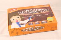 Front view of the boxed electromagnetism educational kit showing branding, project count, and age recommendation.