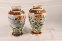 Pair of 9-inch Japanese Satsuma style crackle vases displaying floral decorations and crackled glaze, viewed from the front