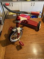 Side angle showing front wheel, handlebar, seat and part of rear wheels