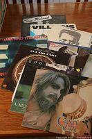 Close-up of multiple vinyl record album covers including Rod Stewart, Art Tatum, Adam and the Ants