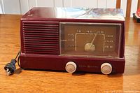 Full front view of vintage maroon General Electric Model 416 radio showing dial, knobs, and cord.