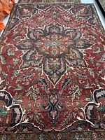 Full view of the rug showing red ground and central medallion