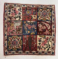 Full view of small square Bakhtiar Persian rug with nine panel design showing various floral and bird motifs in multi colors and ivory border.