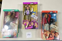Three unopened Mattel Beverly Hills 90210 dolls in original boxes showing Brandon, Brenda, and Dylan characters with packaging and accessories intact.