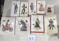 Complete set of nine Hallmark Keepsake Wizard of Oz ornaments displayed with boxes visible.