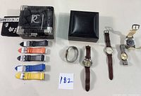Overview of men's watches with boxes, multiple watch bands in various colors, and extra links.