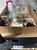 Box of assorted vintage necklaces, rings, earrings, and bracelets including turquoise bead necklace and sterling silver items, some in bags and boxes.