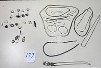 Full lot of sterling silver rings, necklaces, bracelets, and religious medals laid out on white background