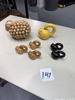 All seven sculptures on table showing ram and six cats in three finishes