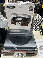 Front and side view of Jensen 3-speed stereo turntable with wood grain finish and black dust cover, in front of original box.