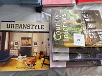 Photo showing the cover of 'Urban Style: Contemporary Interiors' and 'Country Interiors' with several other books stacked.