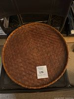 Top-down view showing the full round shape and woven rattan pattern of the tray.