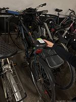 Photo showing the side view of the men's bike focusing on the rear basket rack and saddle area.