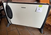 Full view of the front of the Noma heater showing off-white panel, black feet, and power cord coiled.