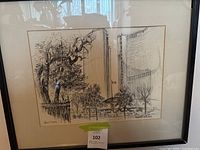 Full view of framed black and white illustration of Toronto City Hall with trees in foreground.