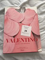 Front cover of the Valentino Themes and Variations book showing the pink pleated dress detail.
