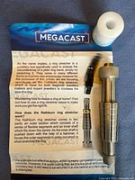 MegaCast ring stretcher and resizer tool with three black inserts and white hammer attachment shown on instruction leaflet.