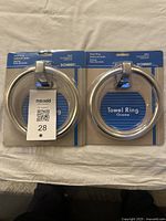 Pair of new Donner towel rings in original manufacturer packaging with blue card and clear plastic cover.