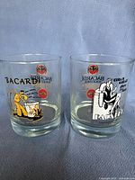 Two Bacardi Together limited edition old fashioned glasses with distinctive colorful graphics and Bacardi branding, numbered 3/4 and 4/4.