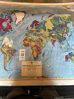 Photo showing the map laid flat, displaying various colored geological regions and a label/title area at the bottom center.