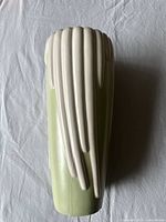 Top view of vase showing cream-colored vertical ribs on pale green body