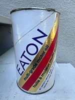 Photo of the front and side of the Eaton motor oil can showing the branding and design details.