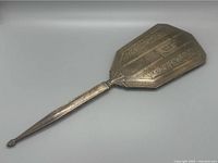 Front view of sterling silver hand mirror showing Art Deco engraved geometric and floral design, monogram J.