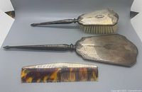 Full view of 3-piece set: hairbrush, hand mirror and comb laid flat