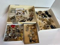 Large lot of vintage costume jewellery sorted in several boxes showing assorted brooches, earrings, chains, rings, pendants.