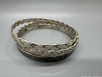 Group image of three silver bracelets showing design variations and condition.
