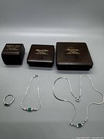 Complete lot with necklace, bracelet, ring and their original plastic dealer cases