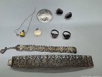 Top-down photo showing all vintage silver jewelry pieces on a white background.