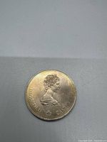 Obverse of the 1976 Canadian $5 silver coin showing Queen Elizabeth II bust and inscriptions.