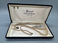 Vintage cultured pearl necklace displayed inside a black box with cream lining, showing the Marvel brand and 14 KT gold label. The necklace includes a sterling stamped clasp.