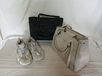 Overall lot including two handbags and one pair of shoes displayed together on a white background.